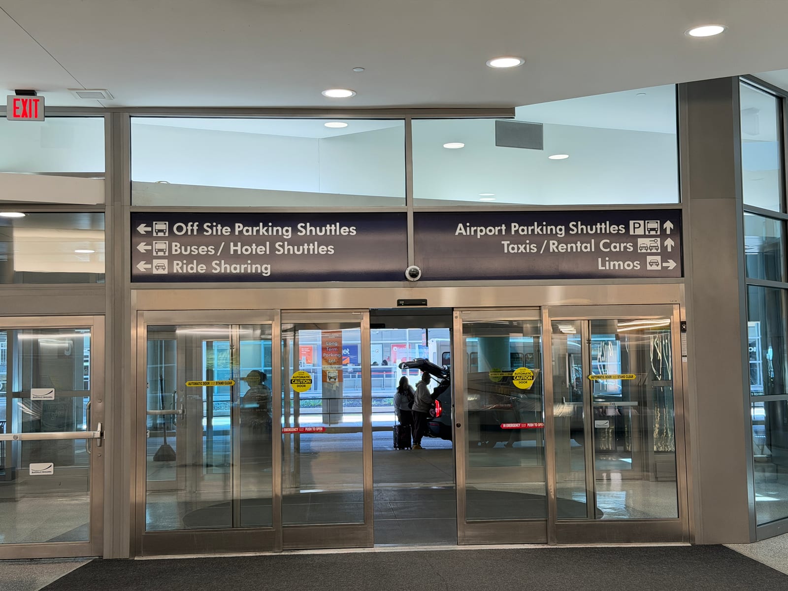 Buffalo Niagara International Airport ground transportation area with taxi and limo signs
